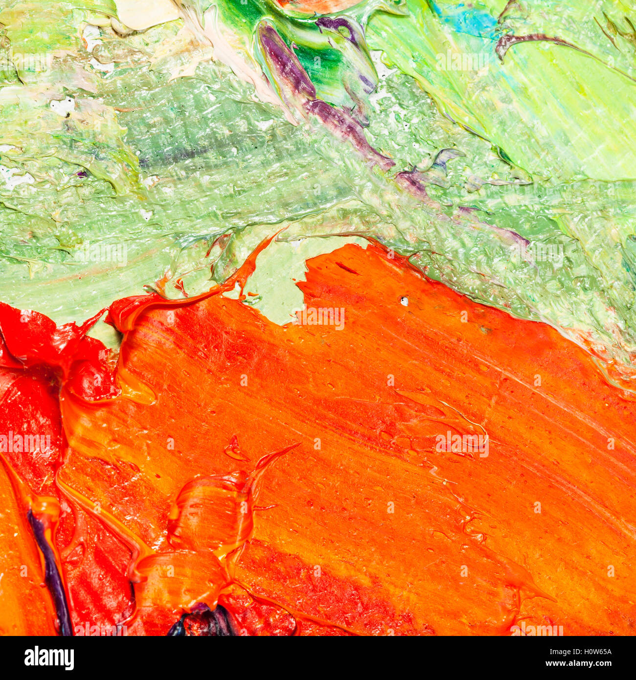orange and green oil paint brush strokes on canvas close up Stock Photo