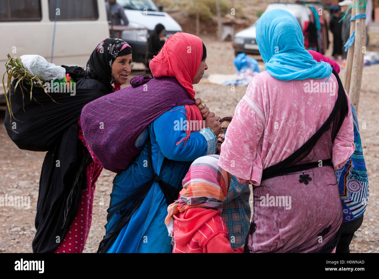Atlas Mountains, Morocco.  Market Scene in Village near Dades Gorge.  Berber Women and Children. Stock Photo