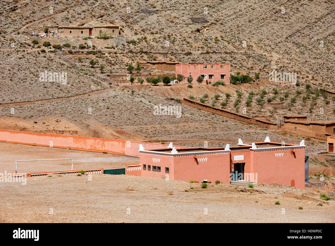 Dades Gorge, Morocco.  Village Houses on Hillside.  Village Soccer Field in Front. Stock Photo