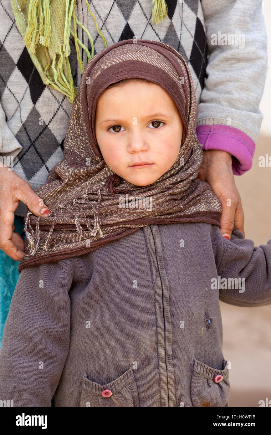 Dades Gorge, Morocco.  Young Berber Girl Standing by her Mother. Stock Photo