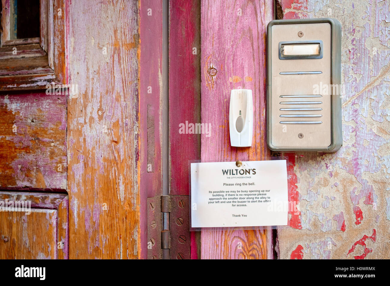 Detail of weathered paint and doorbell at the entrance to Wilton's Music Hall, East London, UK Stock Photo