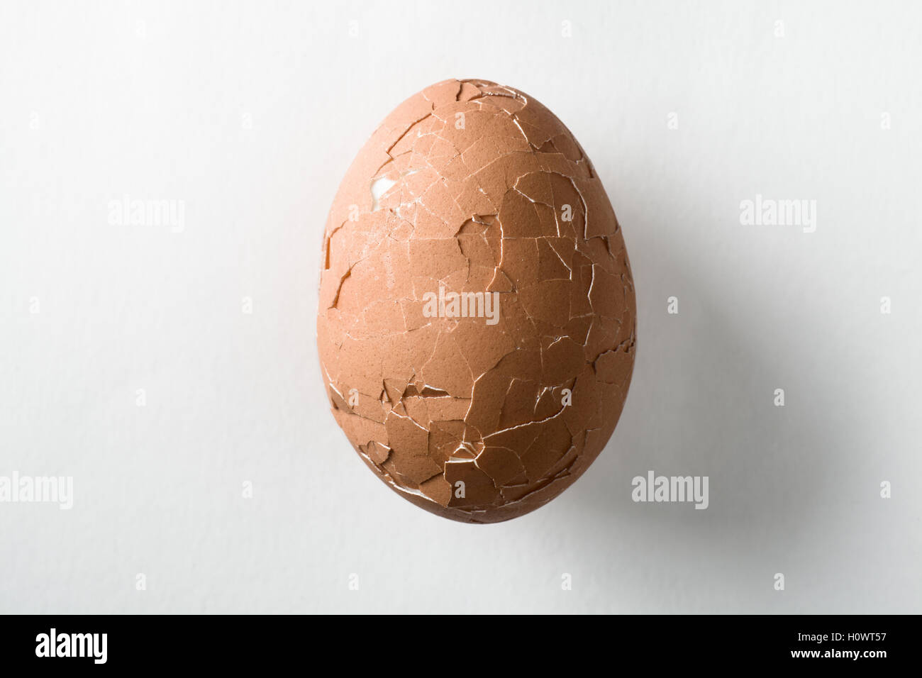 Broken Brownn Egg on White Background Stock Photo