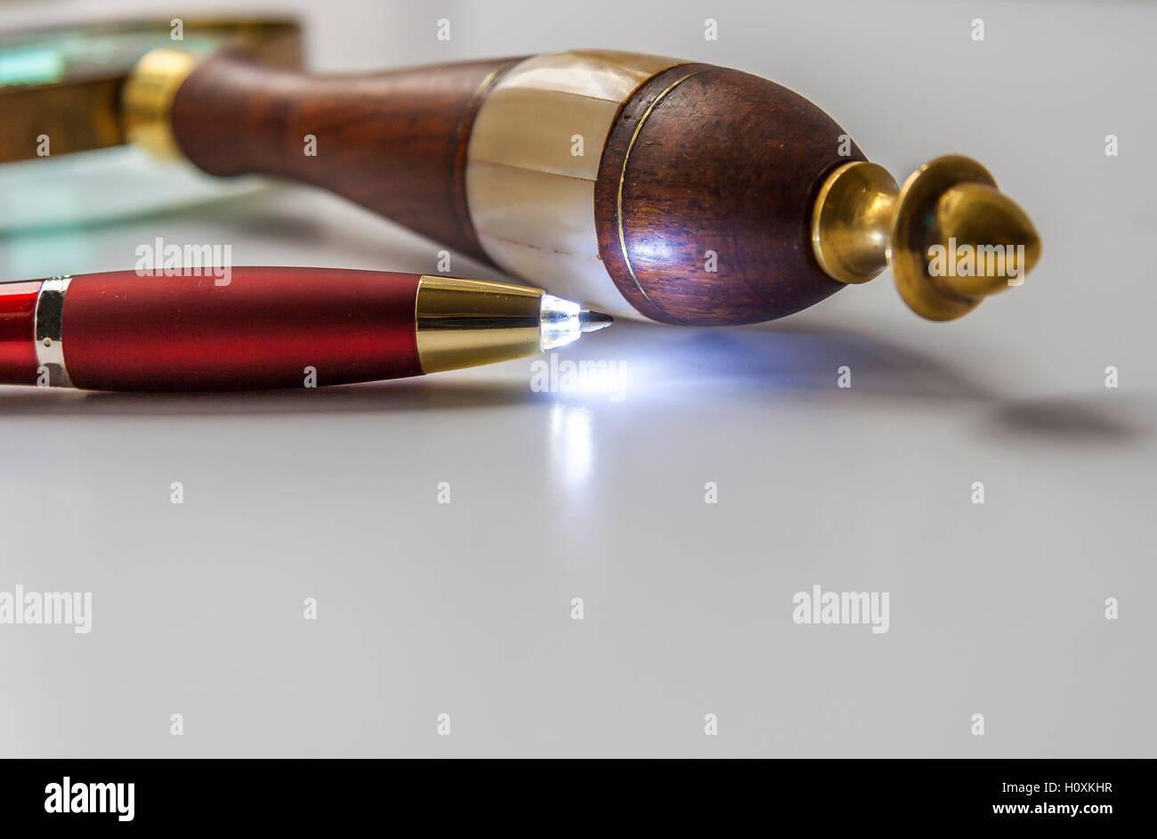 LED Light Ballpoint Pen And Magnifying Glass Stock Photo