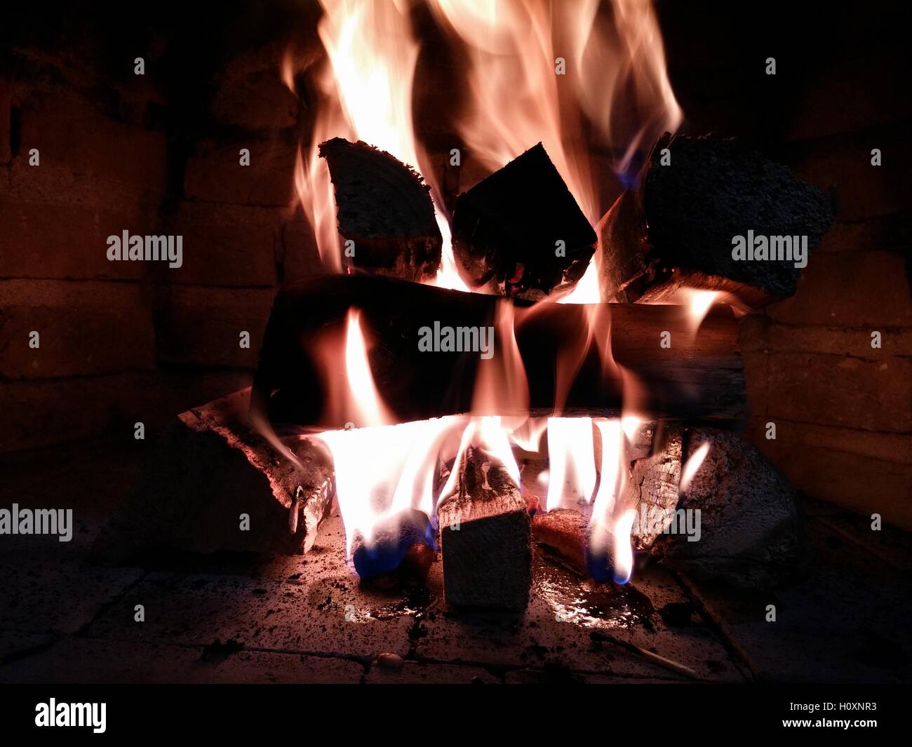 Wood crackling in a fireplace fire Stock Photo