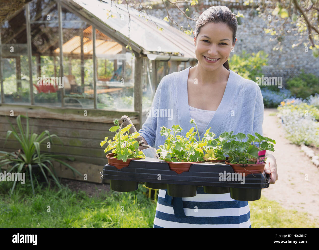 portrait woman potted plant greenhouse garden Stock Photo - Alamy