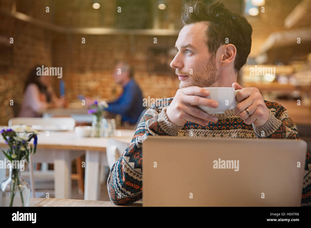 pensive man drinking coffee laptop cafe Stock Photo - Alamy