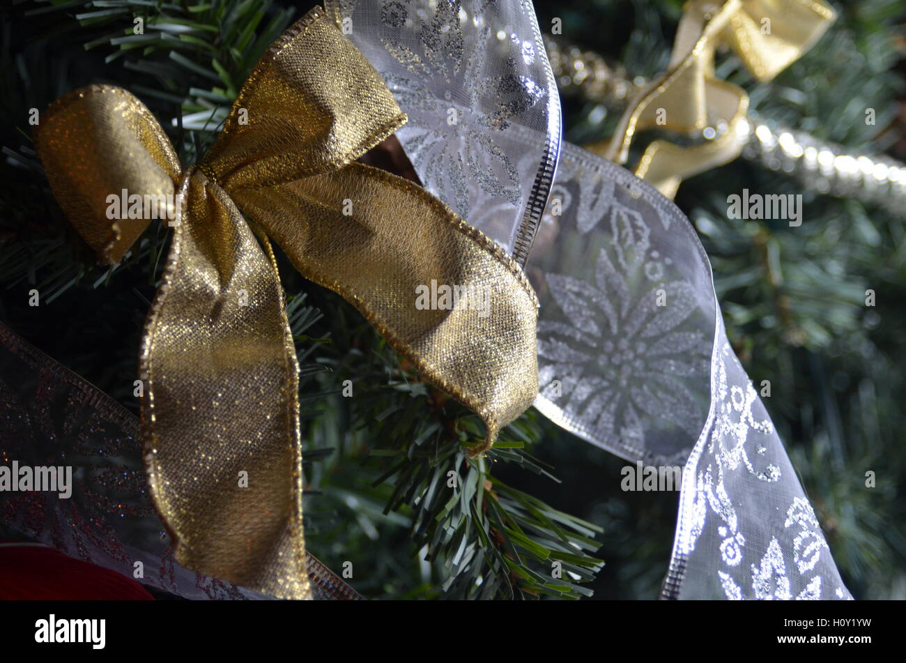Gold And Silver Ribbons Decorations On Green Artificial Christmas