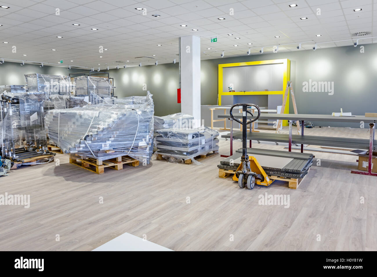 Yellow plastic crates, pallet jack, pedestrian stacker for transport