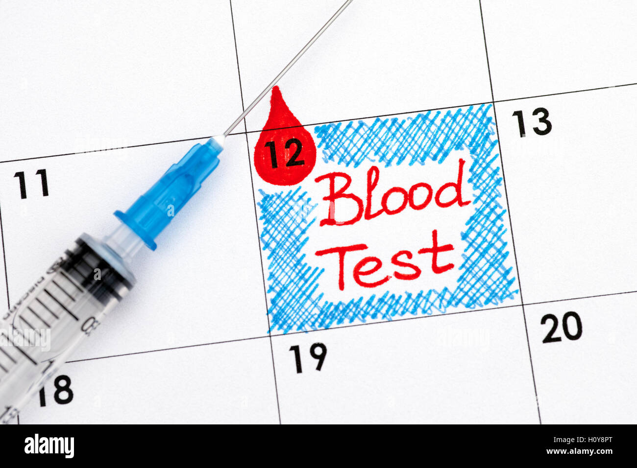 Reminder Blood Test in calendar with syringe. Close up Stock Photo Alamy