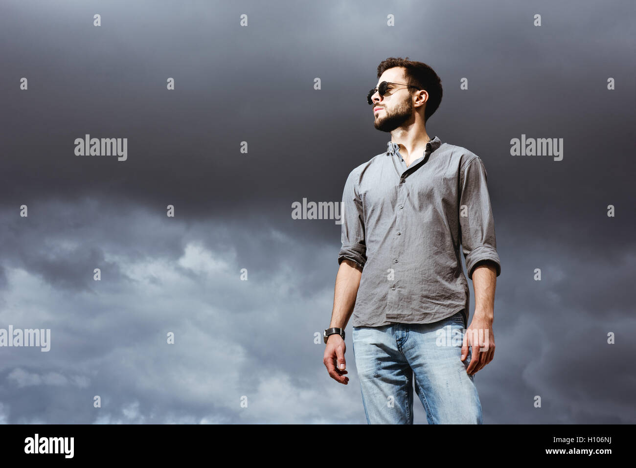 Fashion man posing on the sky bacdrop Stock Photo