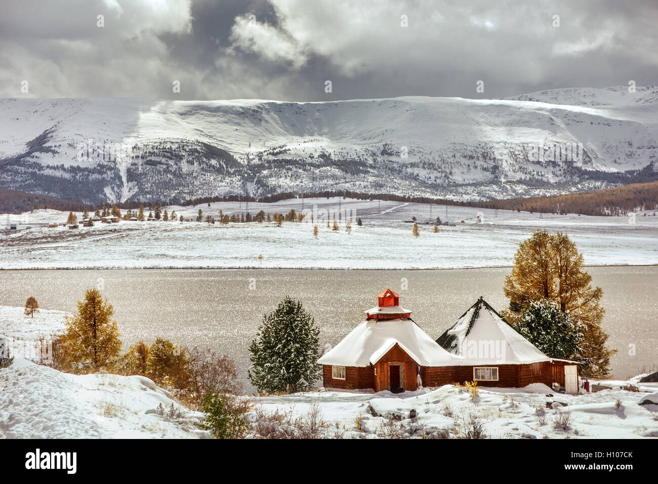 Little house on the snowy mountains background Stock Photo