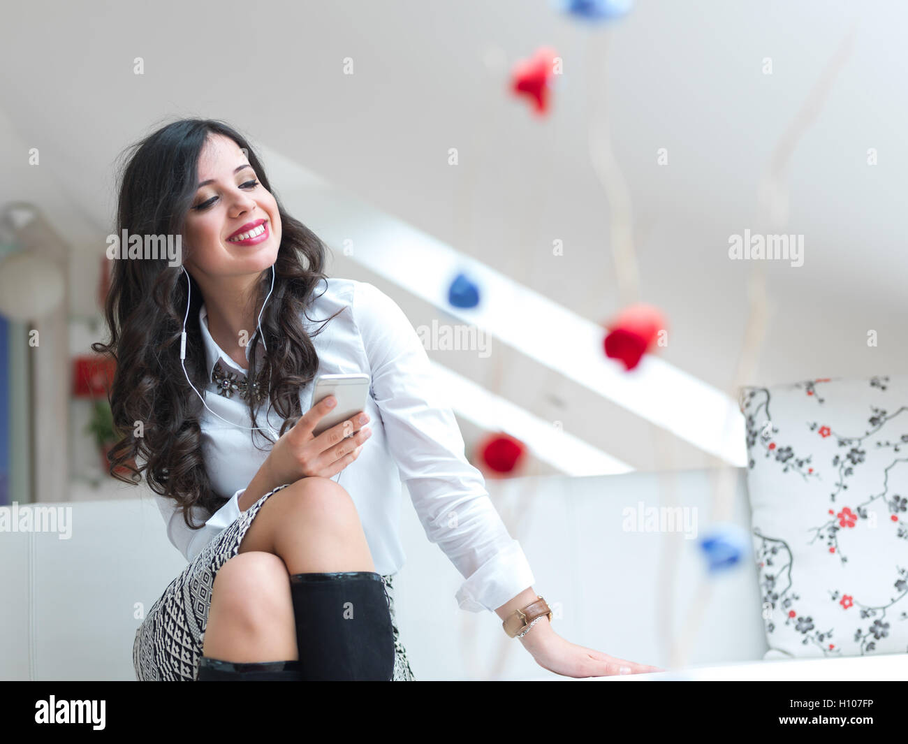 Beautiful woman relaxing in her elegant living room Stock Photo - Alamy