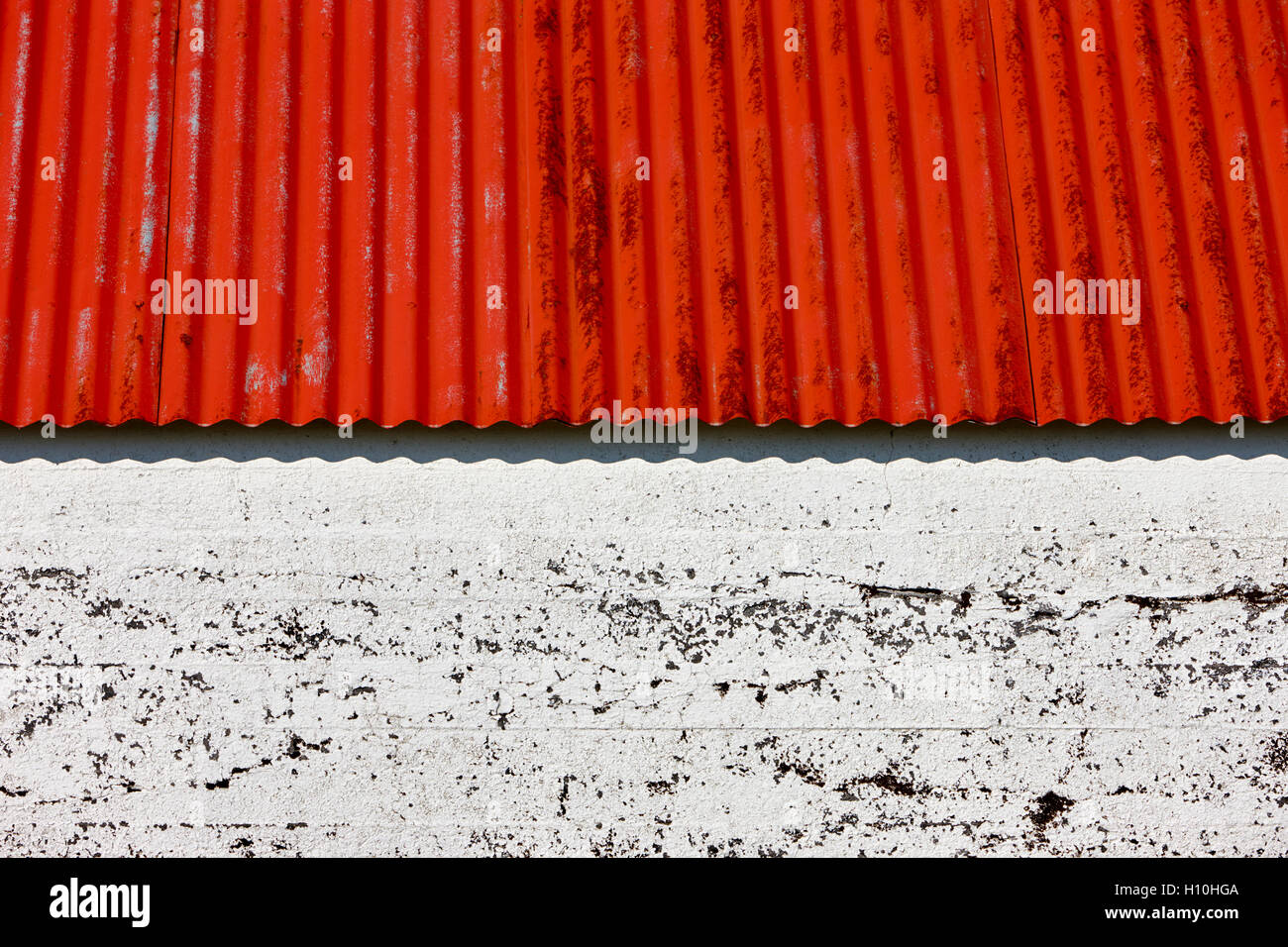 red painted corrugated metal roof on a farm outbuilding in Iceland Stock Photo