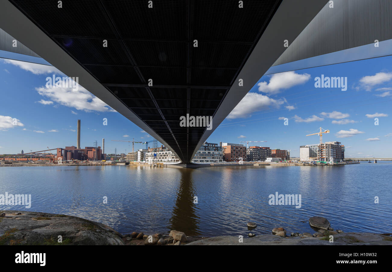 Wide angle view under the Grandpa's Bridge of Helsinki gives a surrealistic perspective on the new Kalasatama residential area. Stock Photo