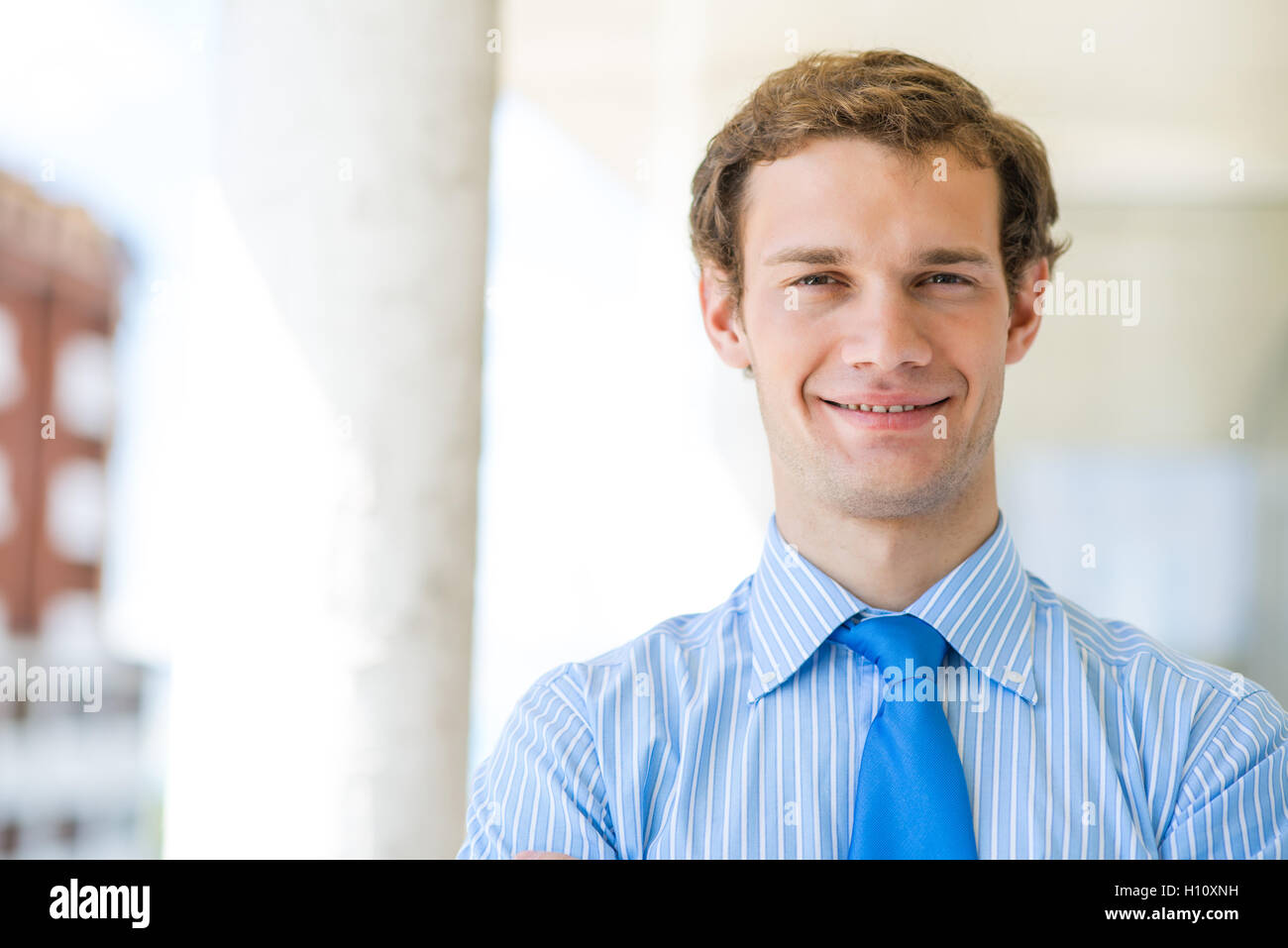 successful young businessman smiling Stock Photo - Alamy