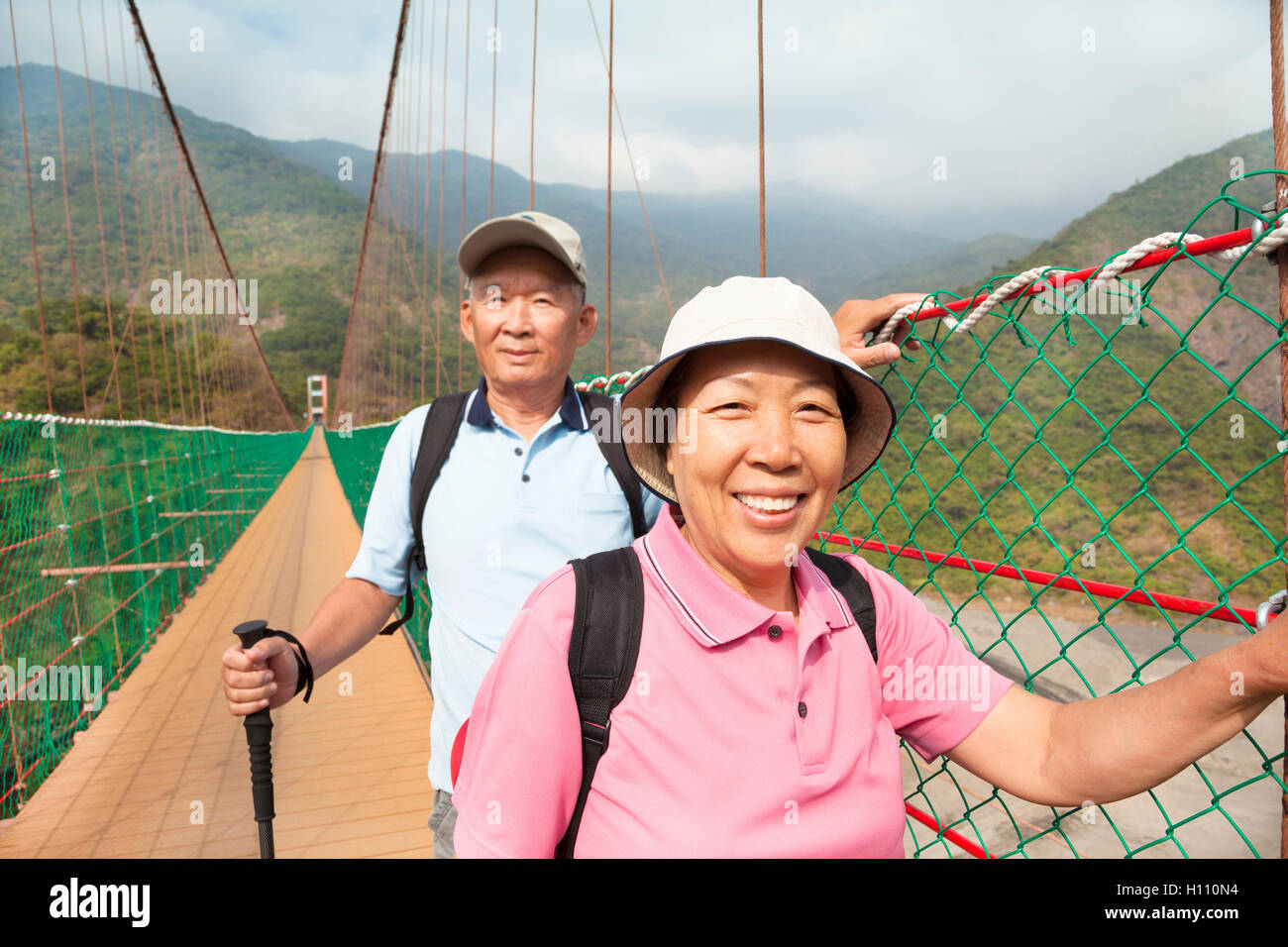 happy asian senior couple walking on the bridge in the nature pa Stock ...