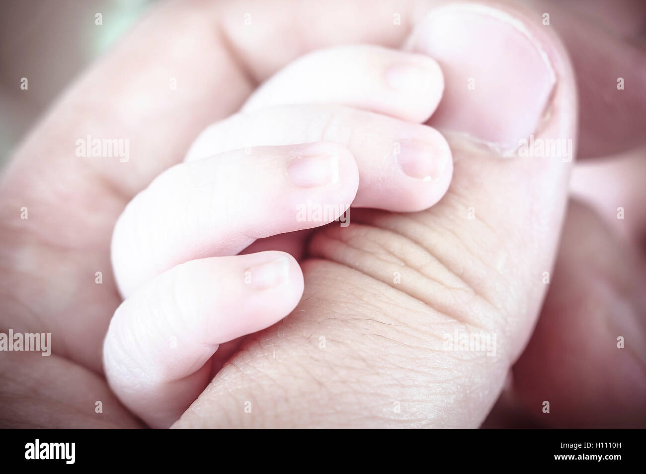 new born baby curled up sleeping on a blanket, multiple expressi Stock