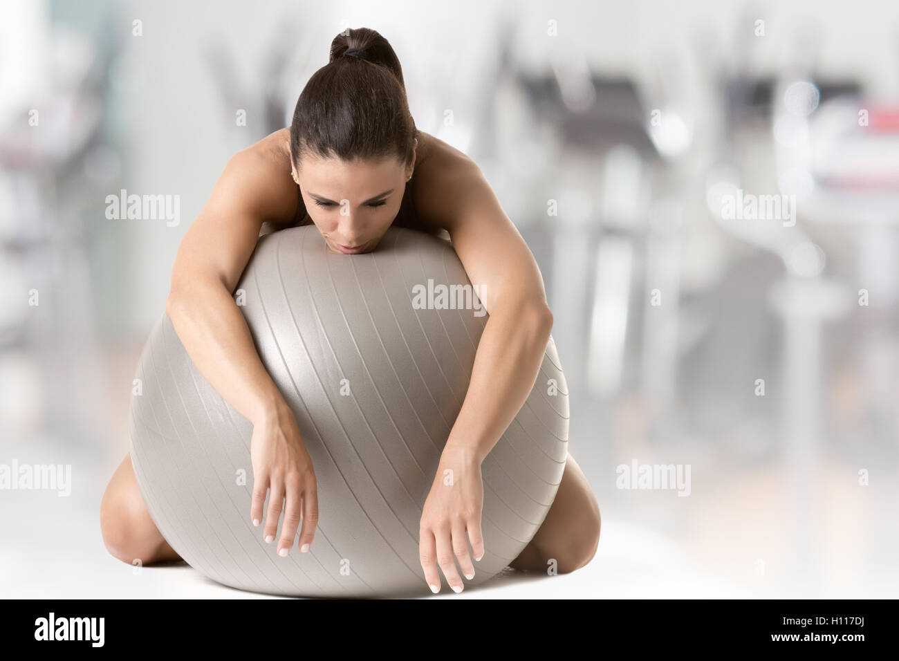 Woman falling asleep in the gym, in a gym Stock Photo
