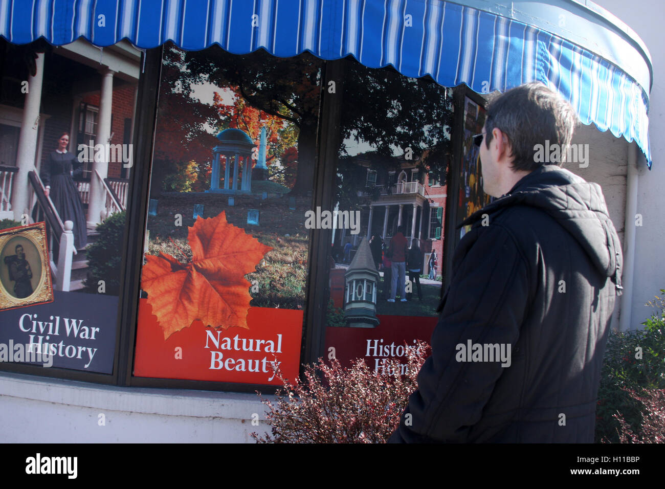 Young man looking at the exterior posters of the visitor center in Lynchburg, Virginia, USA Stock Photo