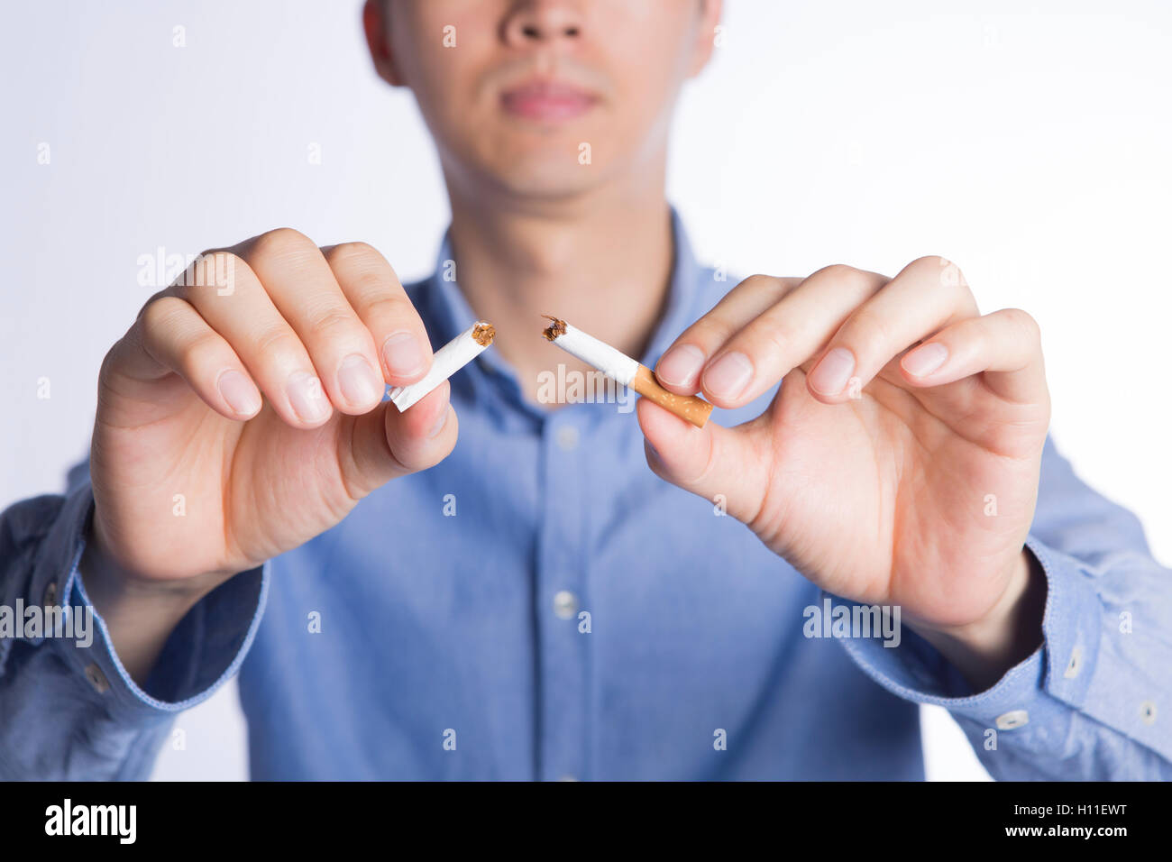 No more smoking, closeup of serious man in blue shirt breaking