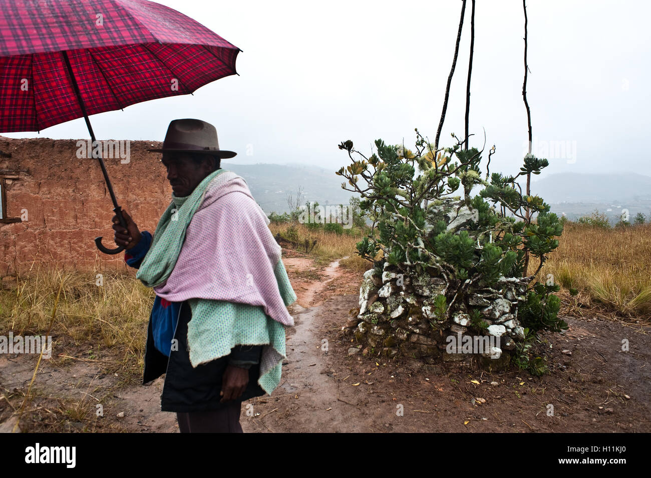 Astrologer ('mpanandro') near the tomb of two 'vazimbe' ( Madagascar). He belongs to the Betsileo ethnic group. Stock Photo