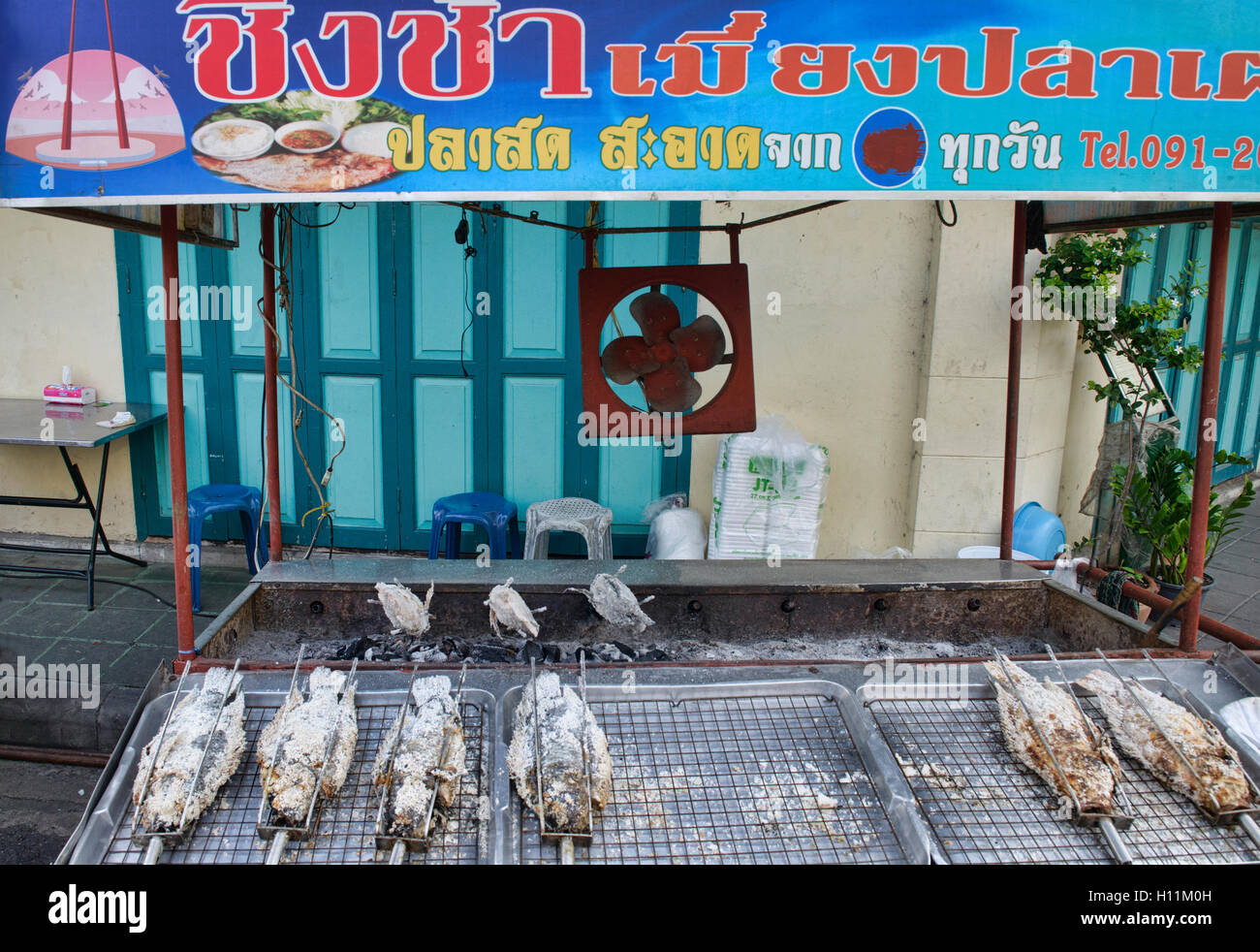 Grilled fish seller in the atmospheric Phraeng Phuton Square in Bangkok