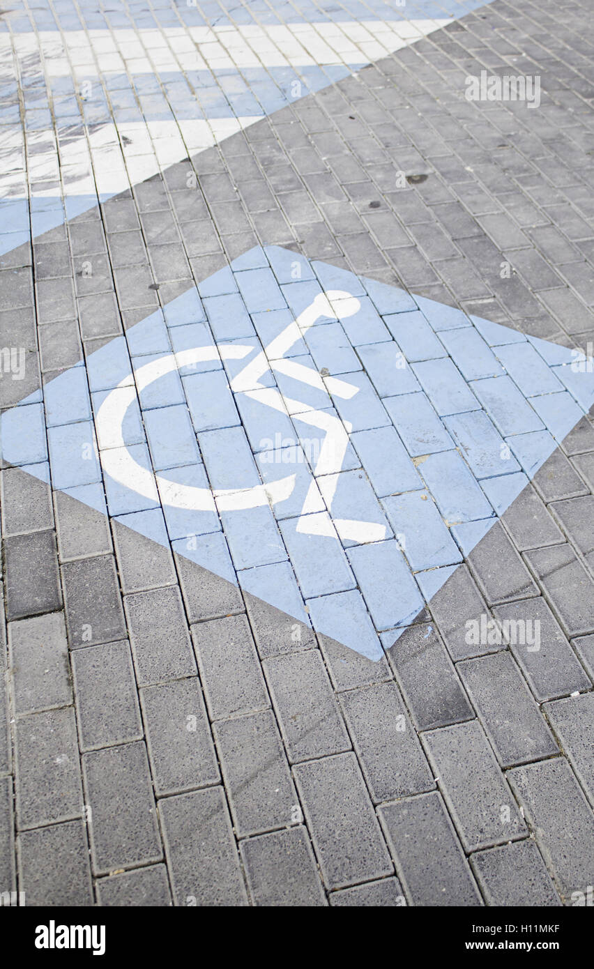 Blue Disabled sign on urban road symbol Stock Photo - Alamy
