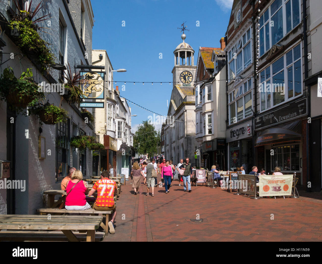 View along pedestrianised St Edmund's Street Weymouth Town centre Dorset England UK busy shopping street with Golden Lion Inn and  historic Guidhall Stock Photo