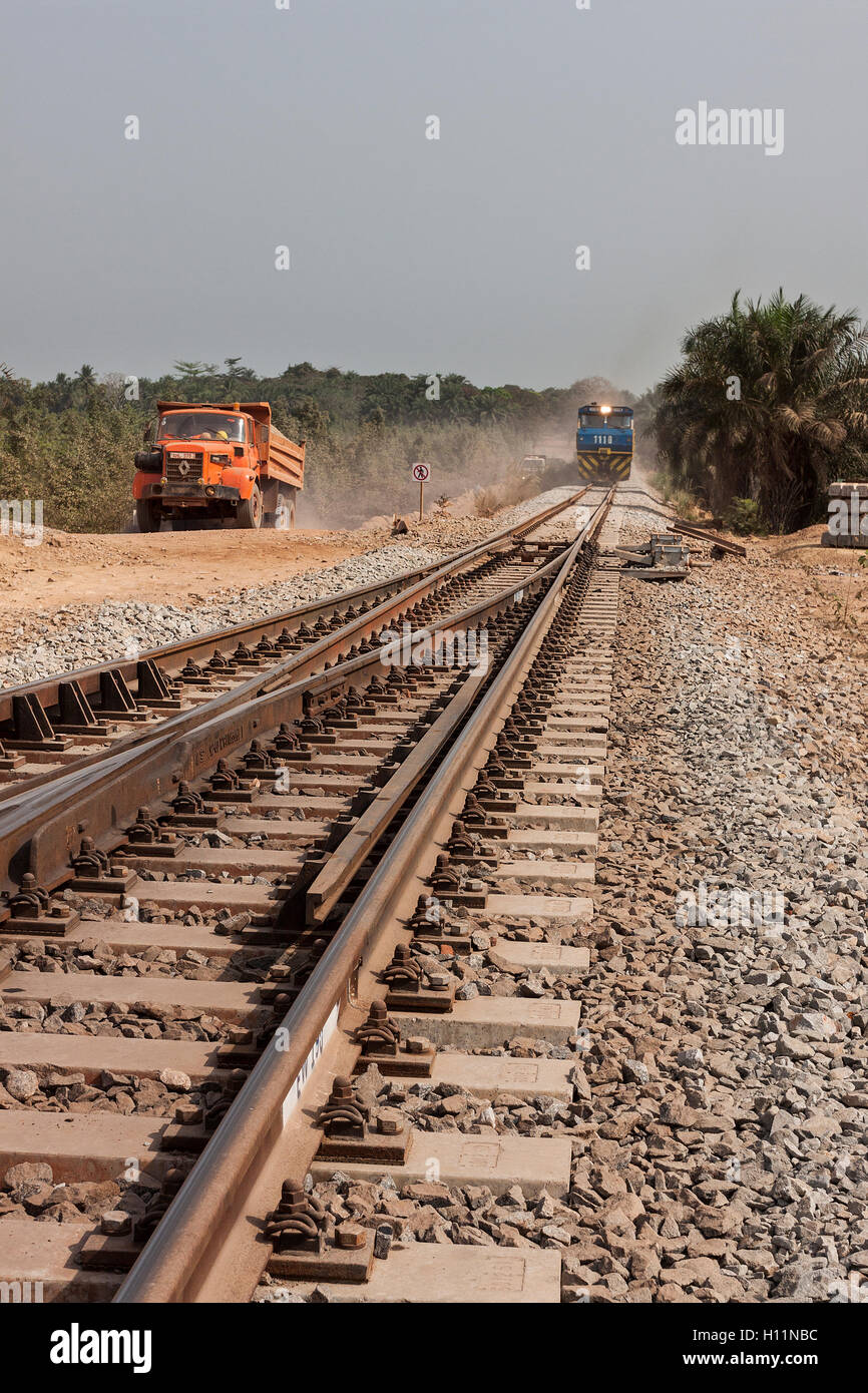 Port operations and rail head for managing and transporting iron ore. Ore train in distance approaching rail points with construction traffic on left Stock Photo