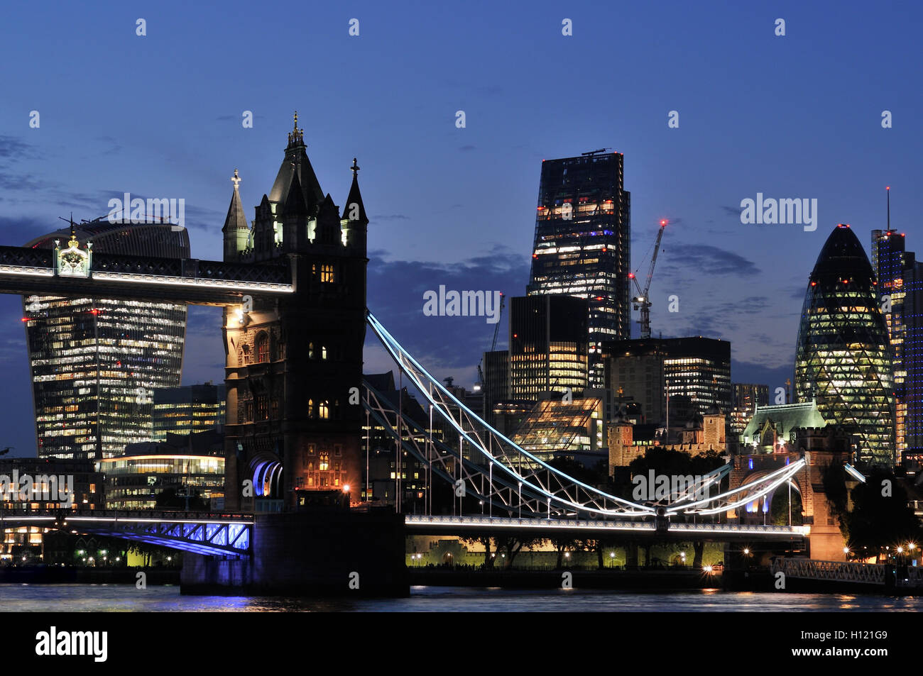 The City of London UK and Tower Bridge at dusk from the south bank of the Thames Stock Photo