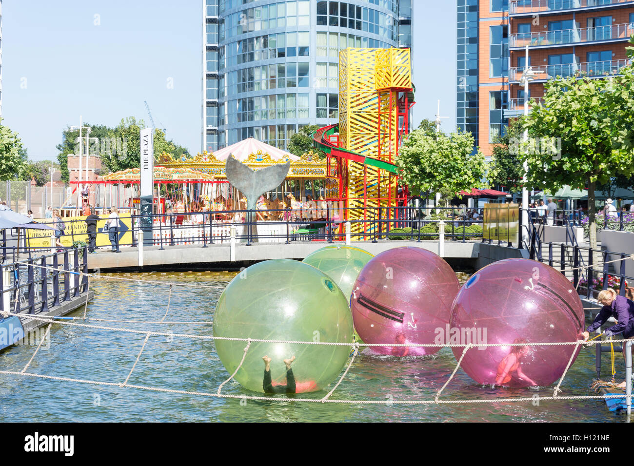 Children water balling at The Plaza, Gunwharf Quays, Portsmouth Harbour, Portsmouth, Hampshire, England, United Kingdom Stock Photo