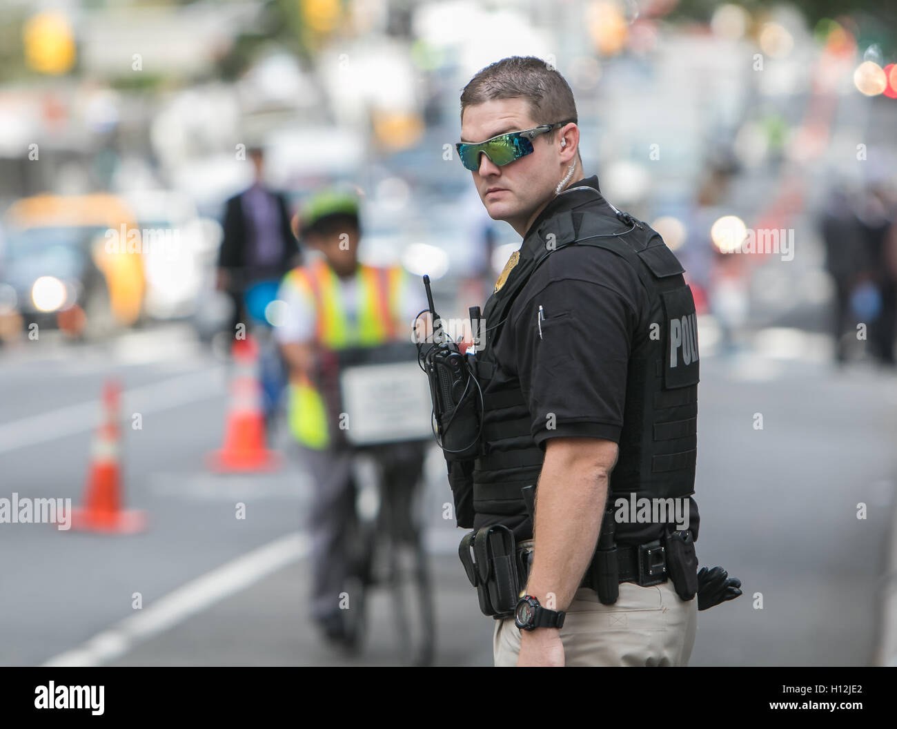 A Secret Service agent is helping direct traffic and keep the reserved lane clear during a UN General Assembly. Stock Photo