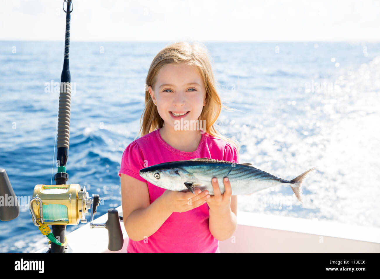 https://c8.alamy.com/comp/H13EC6/blond-kid-girl-fishing-tuna-bonito-sarda-fish-happy-catch-H13EC6.jpg