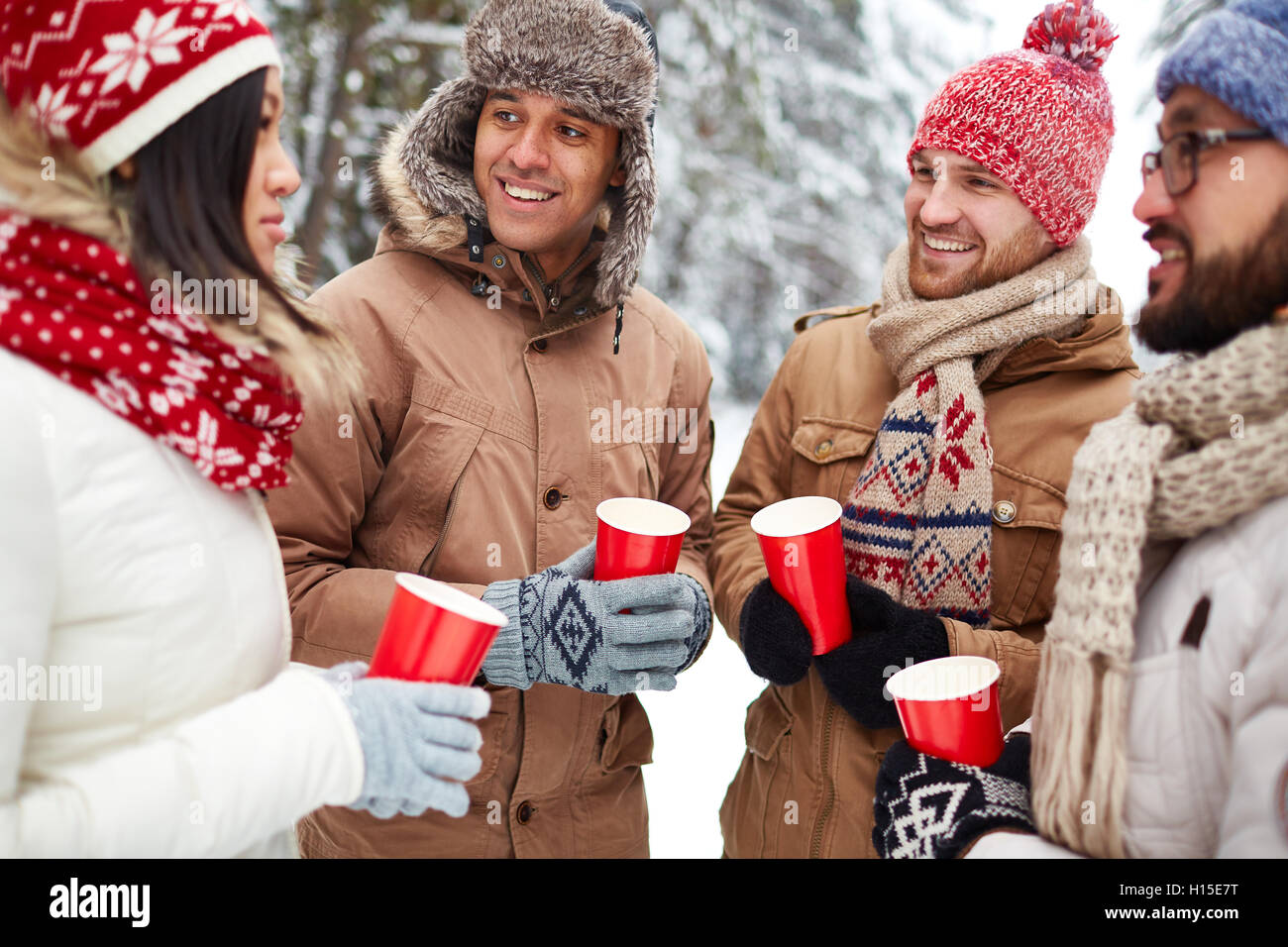 Friends with hot drinks Stock Photo - Alamy