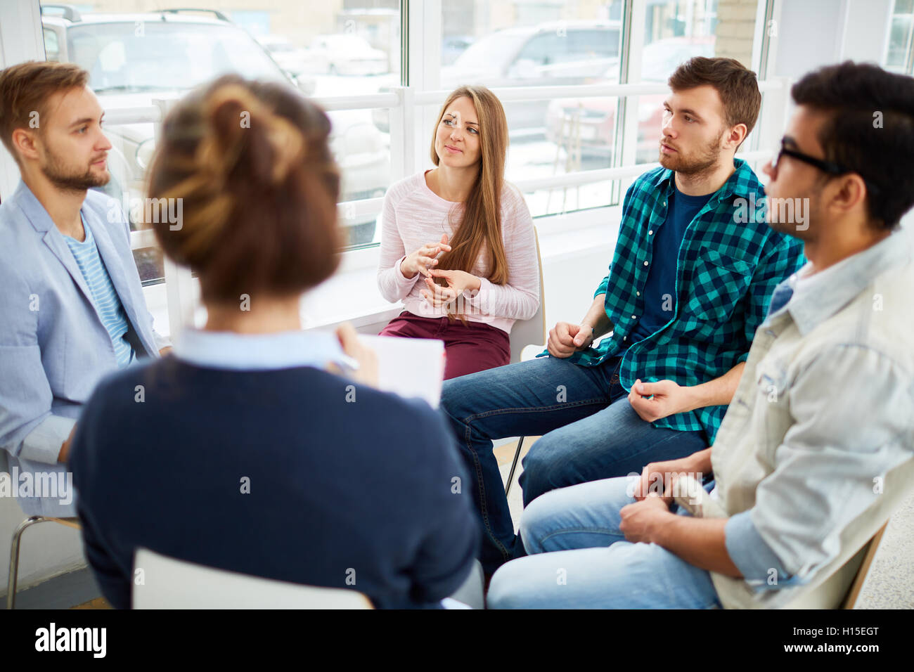 Listening to groupmate Stock Photo - Alamy