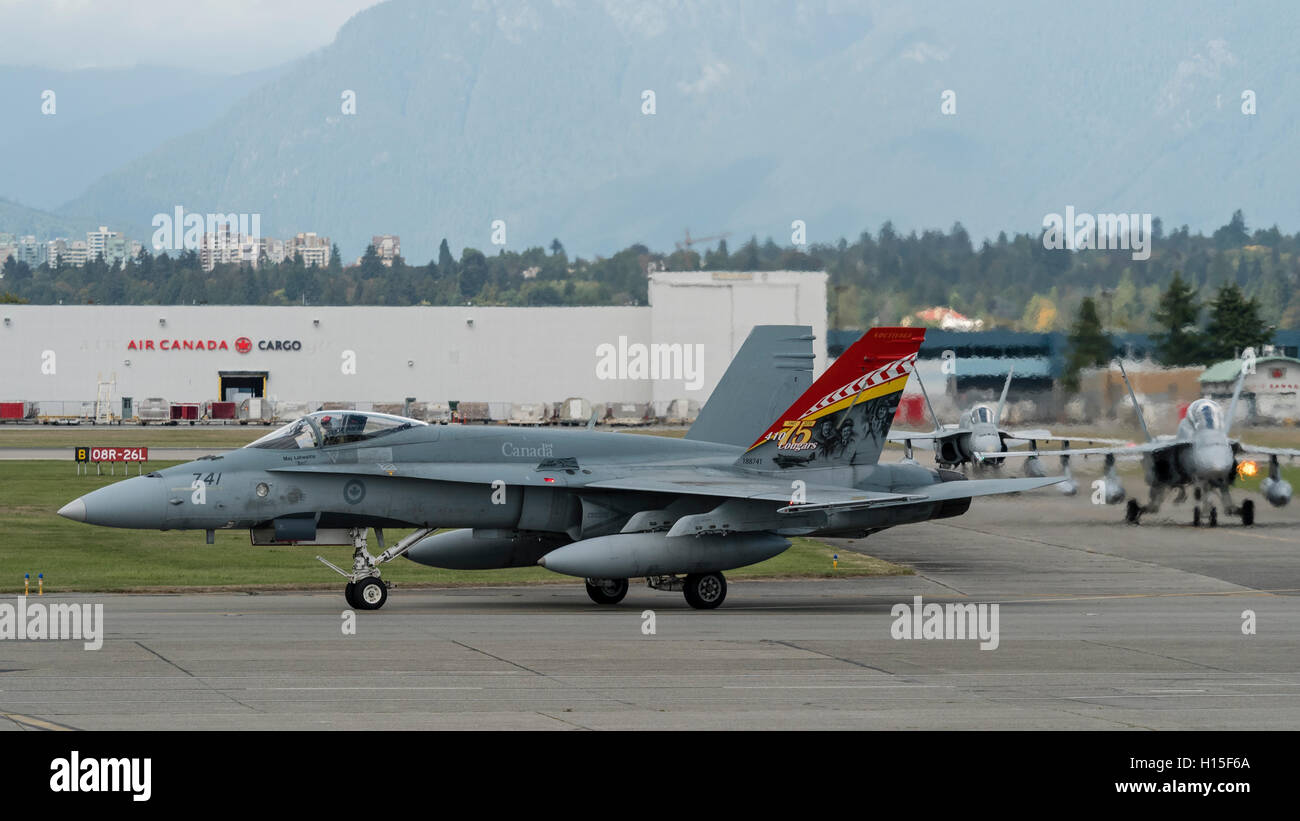 CF-18A Hornet fighter jets of the Royal Canadian Air Force taxi along the tarmac at Vancouver International Airport, Canada Stock Photo