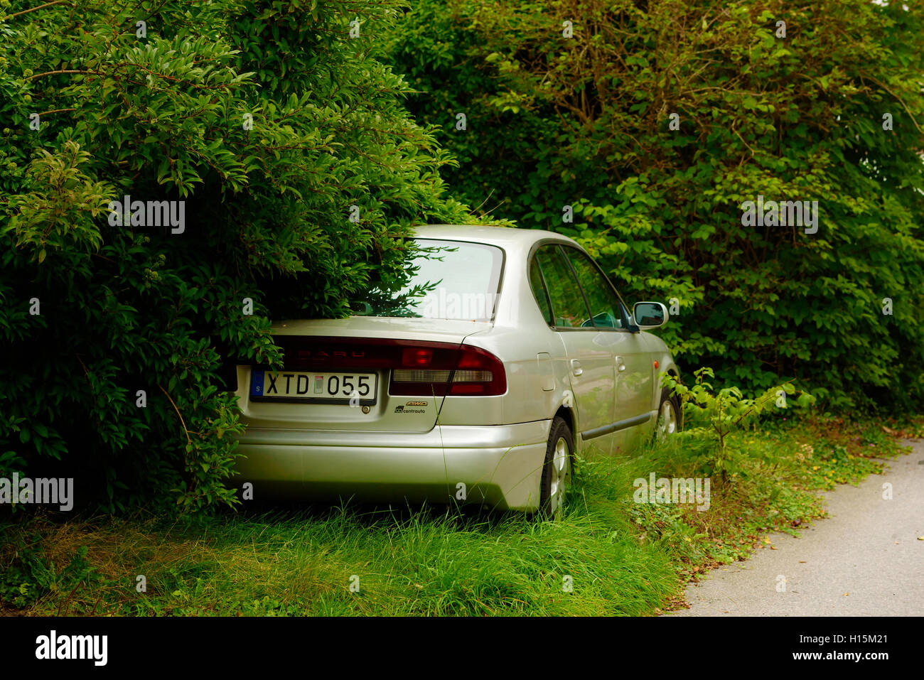 Skarhamn, Sweden - September 9, 2016: Environmental documentary of a 2000 Subaru Legacy parked roadside a long time ago and dese Stock Photo