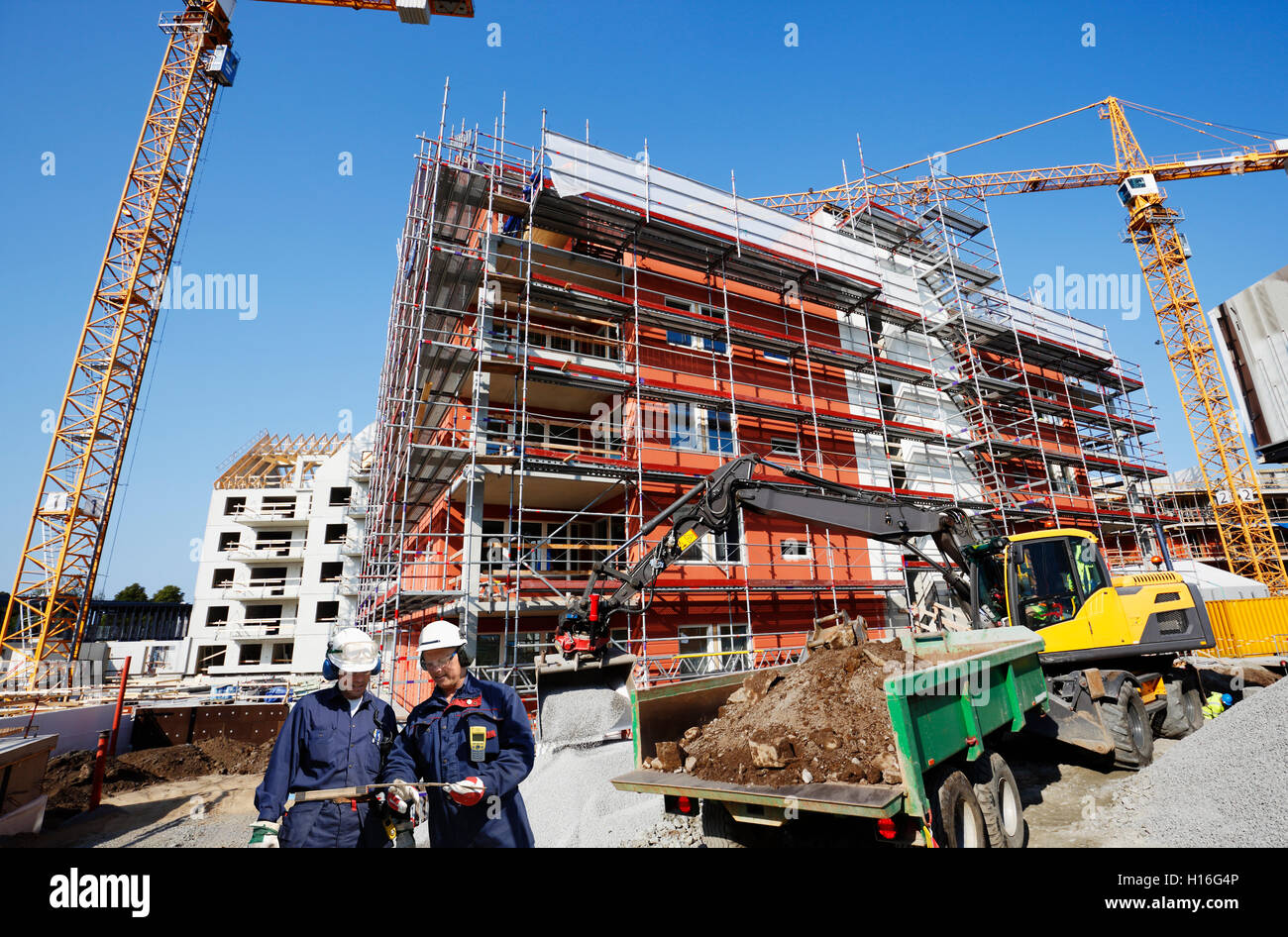 two building workers, construction and scaffoldings Stock Photo