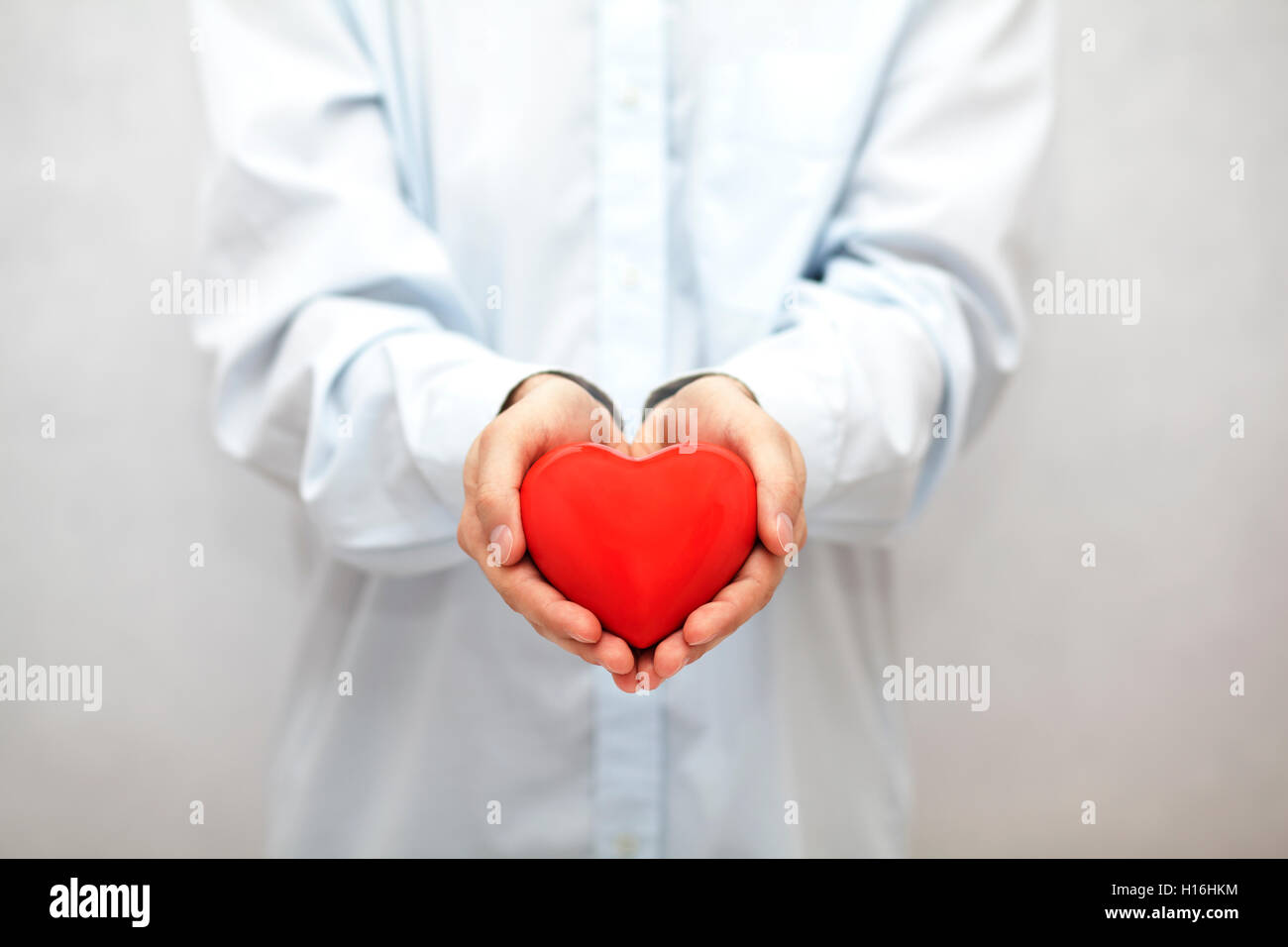 Red heart in hands Stock Photo