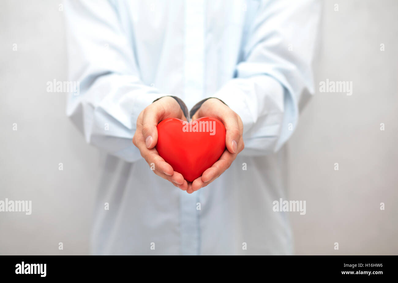 Red heart in hands Stock Photo