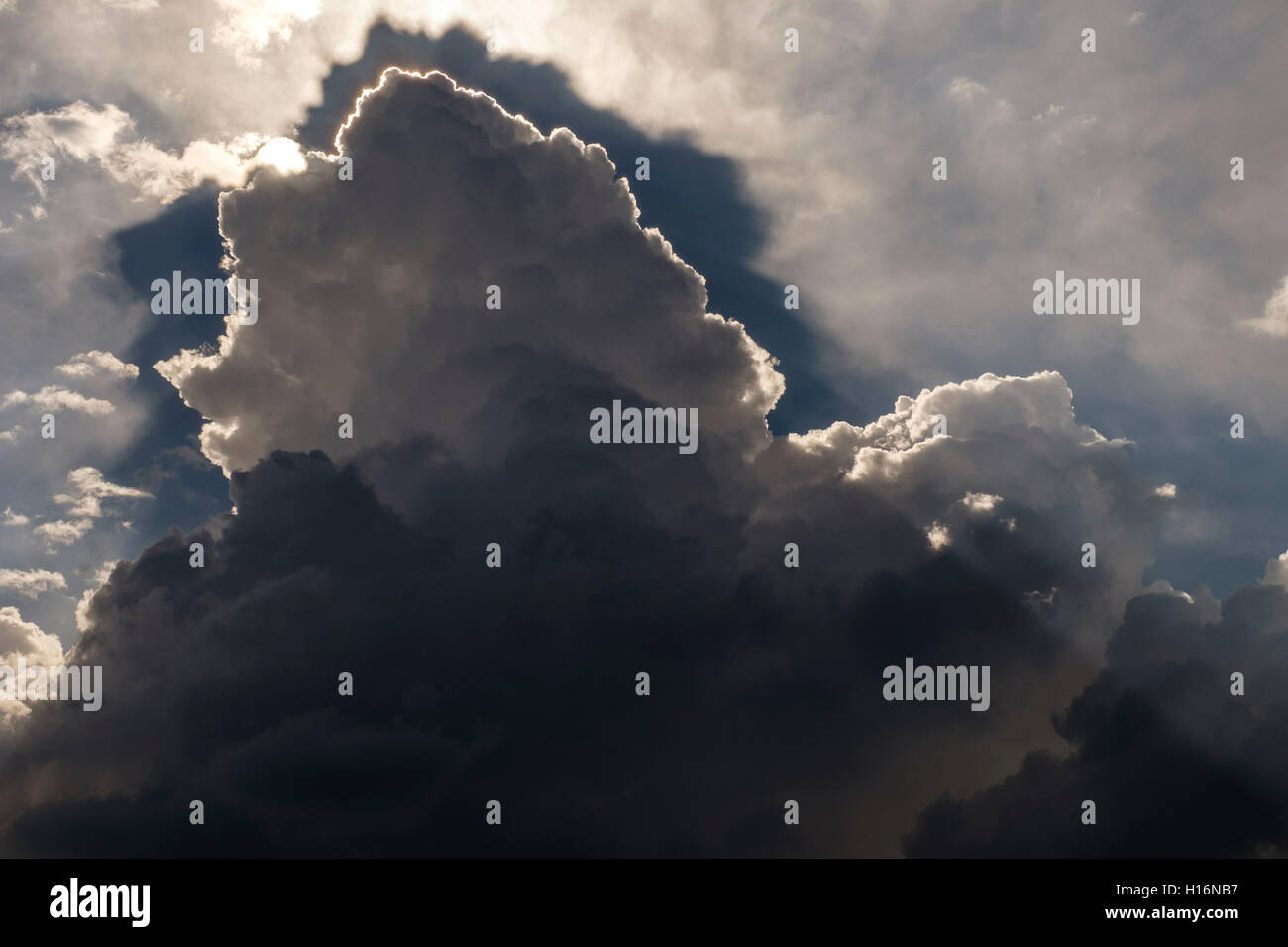Thunderclouds, Altocumulus, sun behind grey clouds Stock Photo