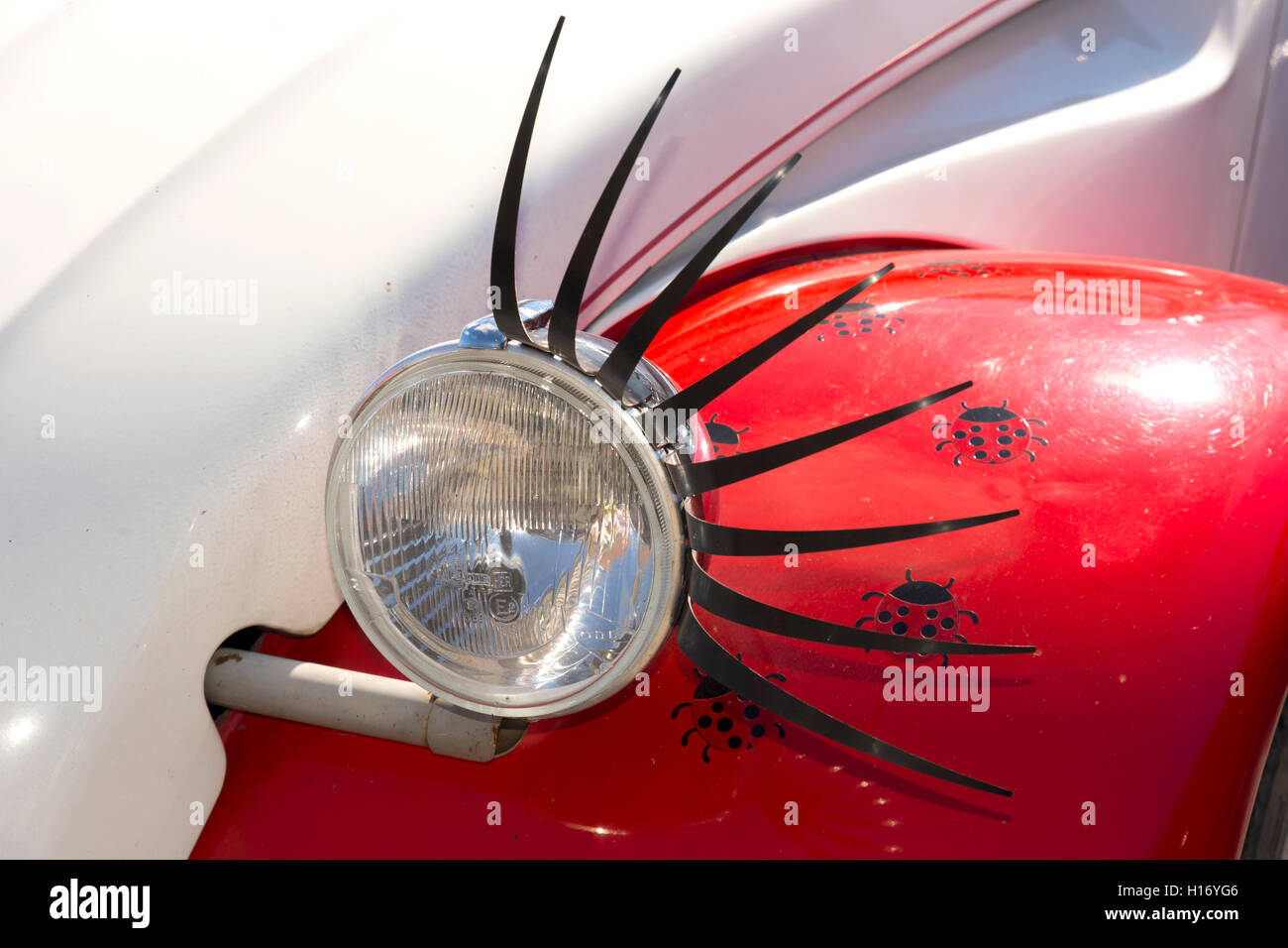 headlight of a car adorned with eyelashes like an eye Stock Photo