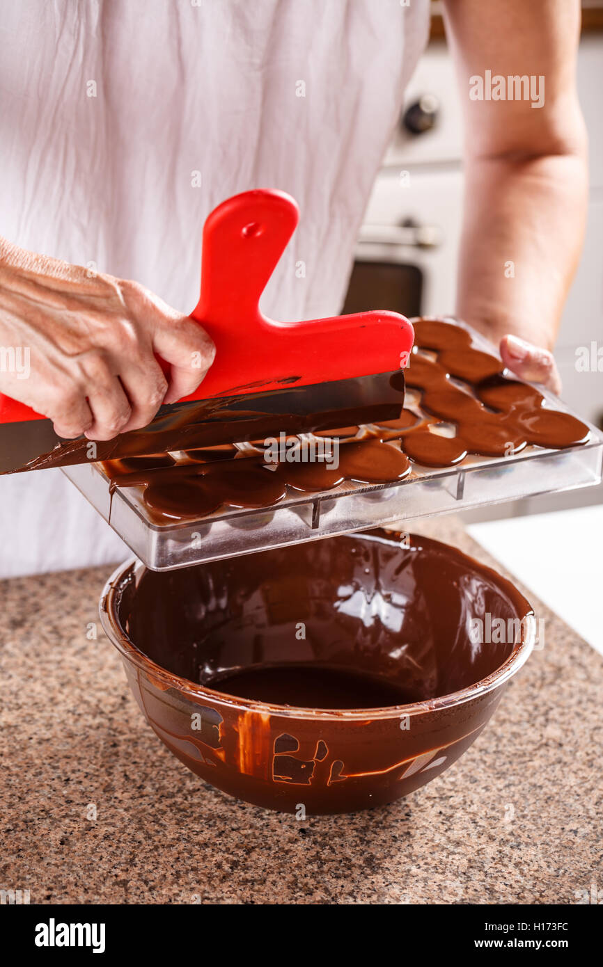 Making chocolate candies in mold Stock Photo Alamy