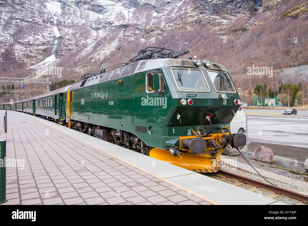 The train at the platform amid high mountains Stock Photo