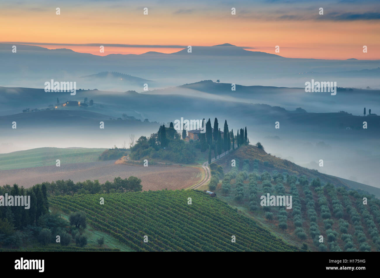 Tuscany. Image of Tuscany landscape during foggy autumn sunrise. Stock Photo