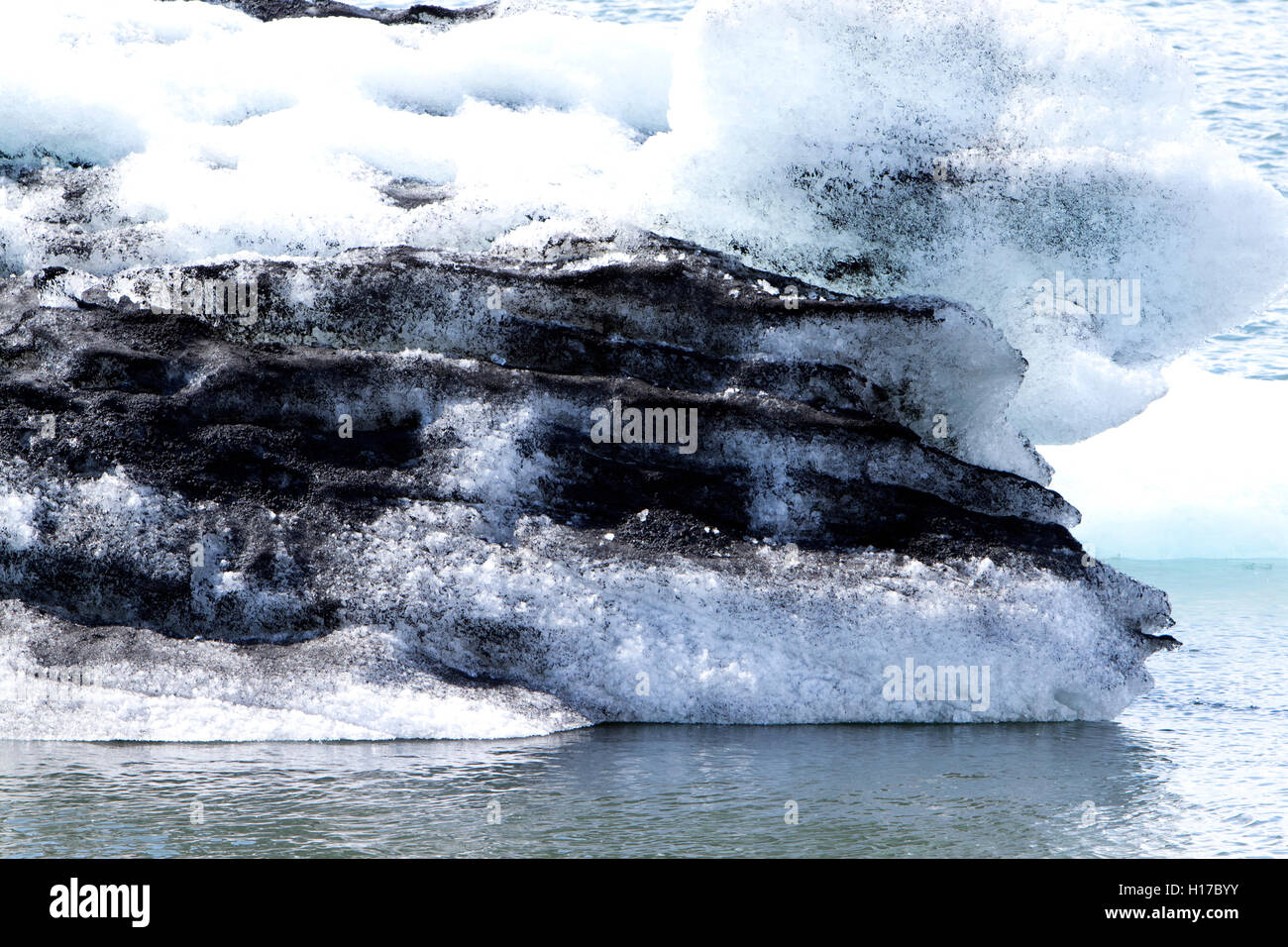 cross section of glacial ice with ash in iceberg Jokulsarlon glacial lagoon Iceland Stock Photo