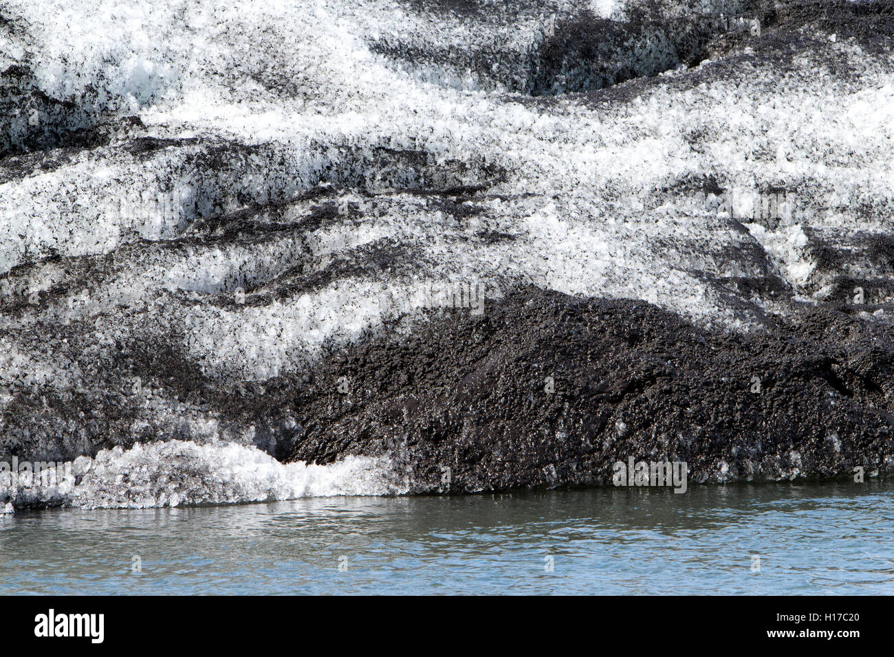 cross section of glacial ice with ash in iceberg Jokulsarlon glacial lagoon Iceland Stock Photo