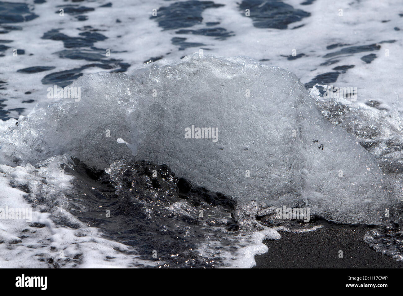 Ice washed up on black sand beach at jokulsarlon iceland Stock Photo