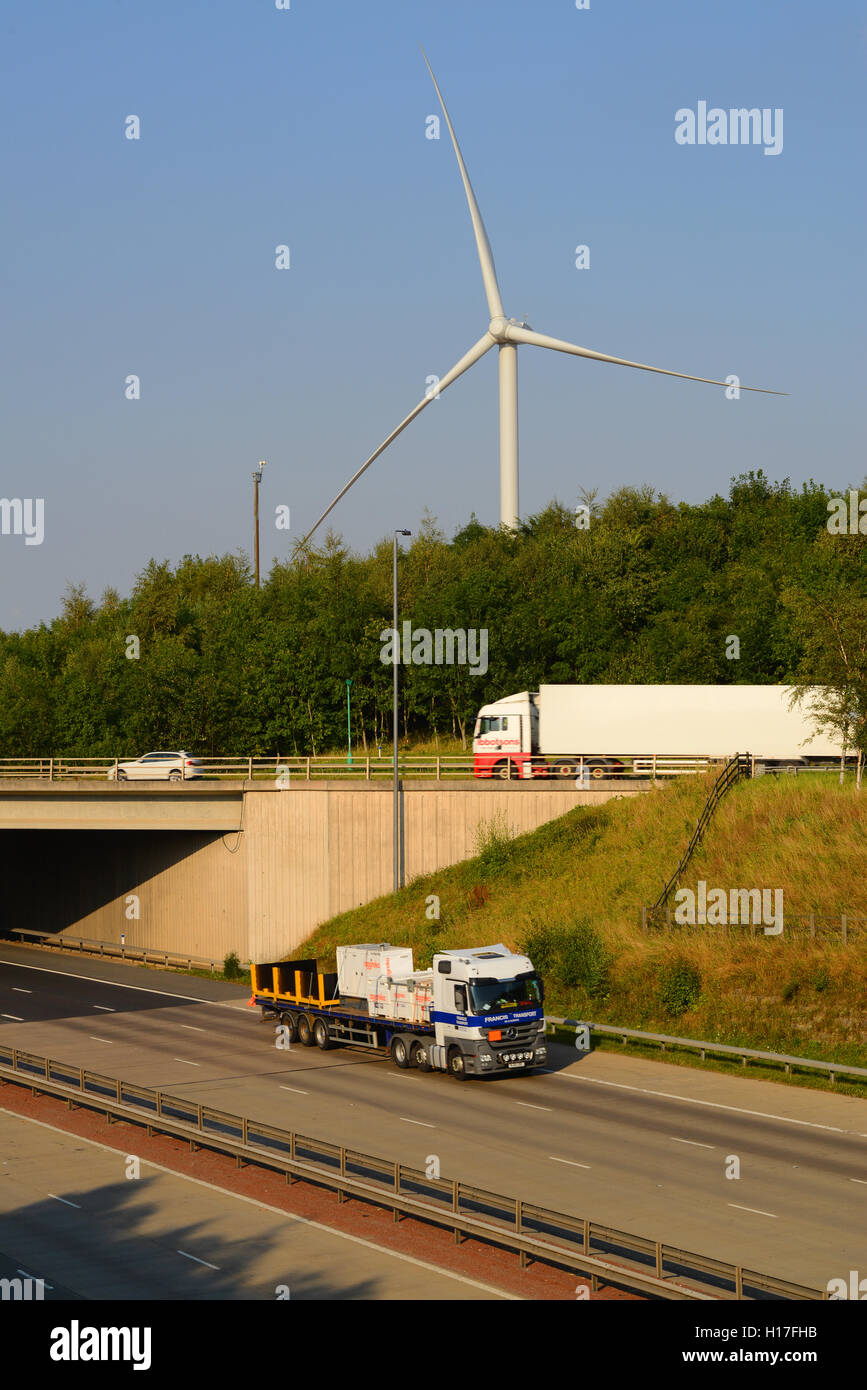 traffic passing electricity generating windmills by A1/M motorway leeds united kingdom Stock Photo