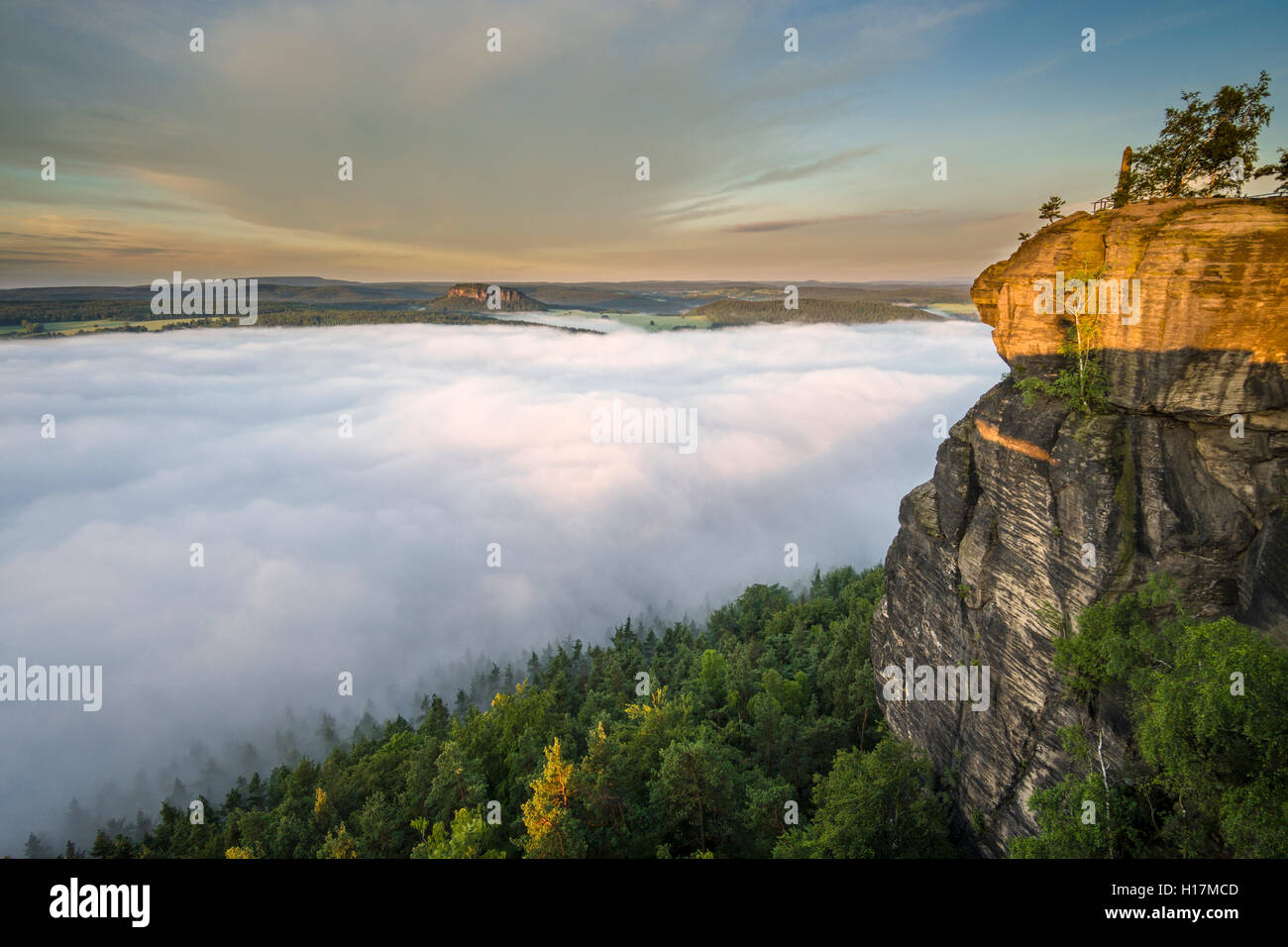 Thick fog is filling the valley of the river Elbe in Elbsandsteingebirge, seen from Lilienstein at sunrise, Königstein, Saxony Stock Photo